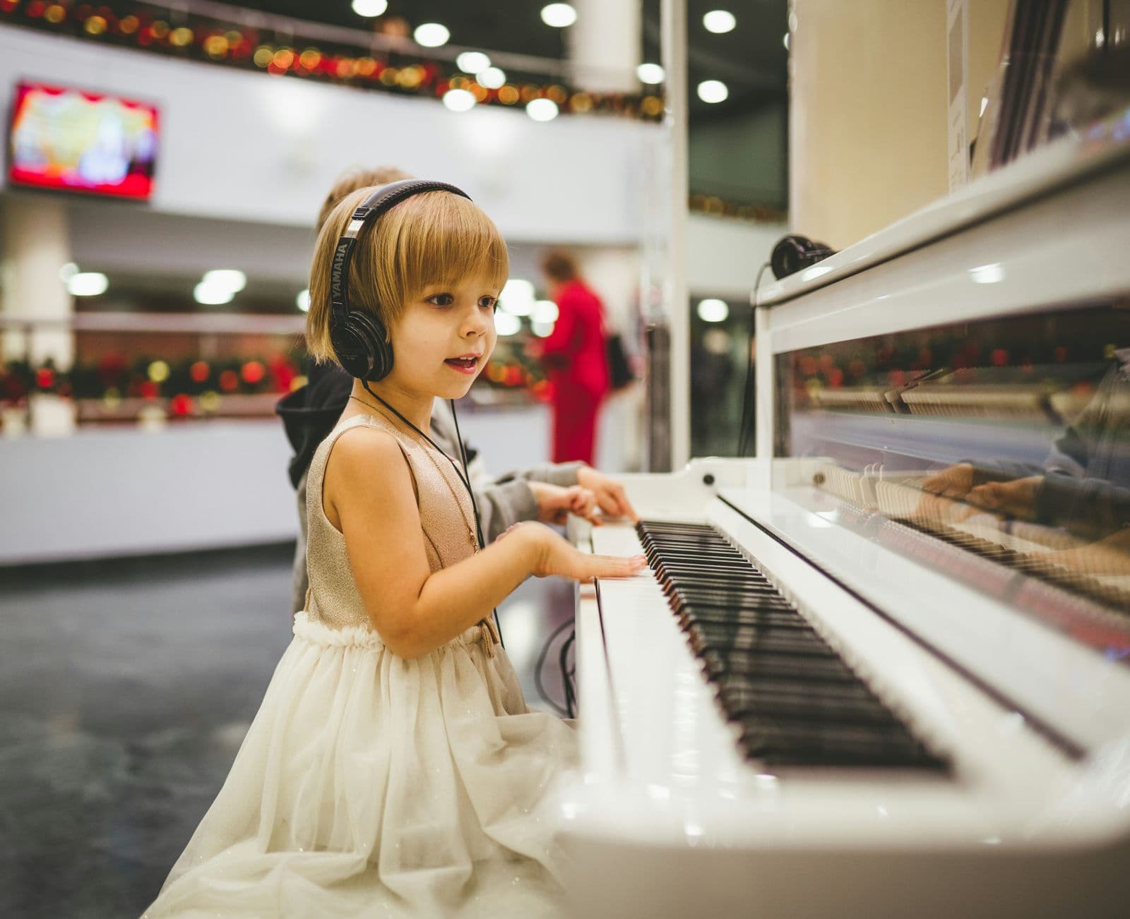 A young child's hands resting on piano keys